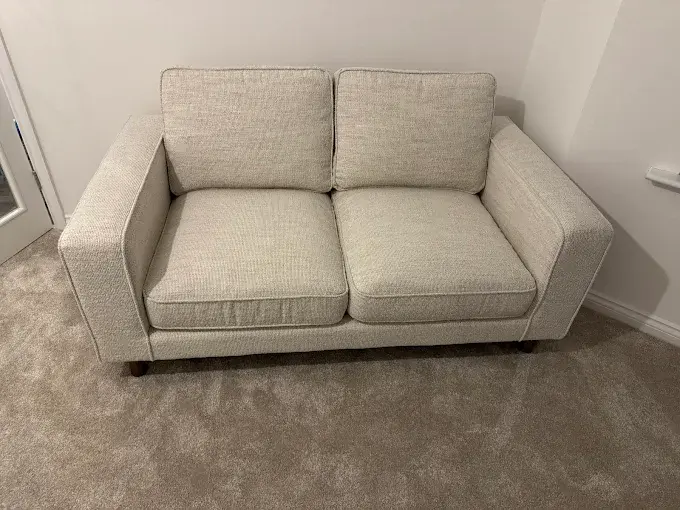 Clean light grey two-seat sofa