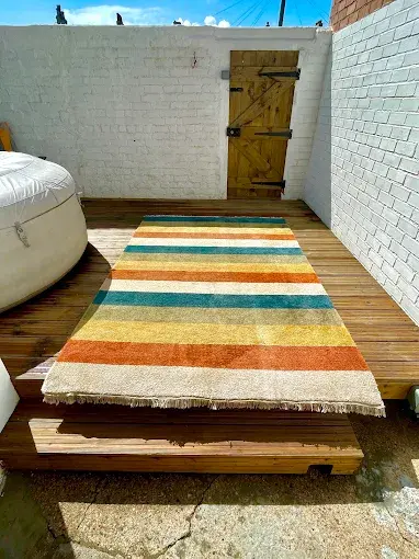 Freshly cleaned striped rug laid out to dry